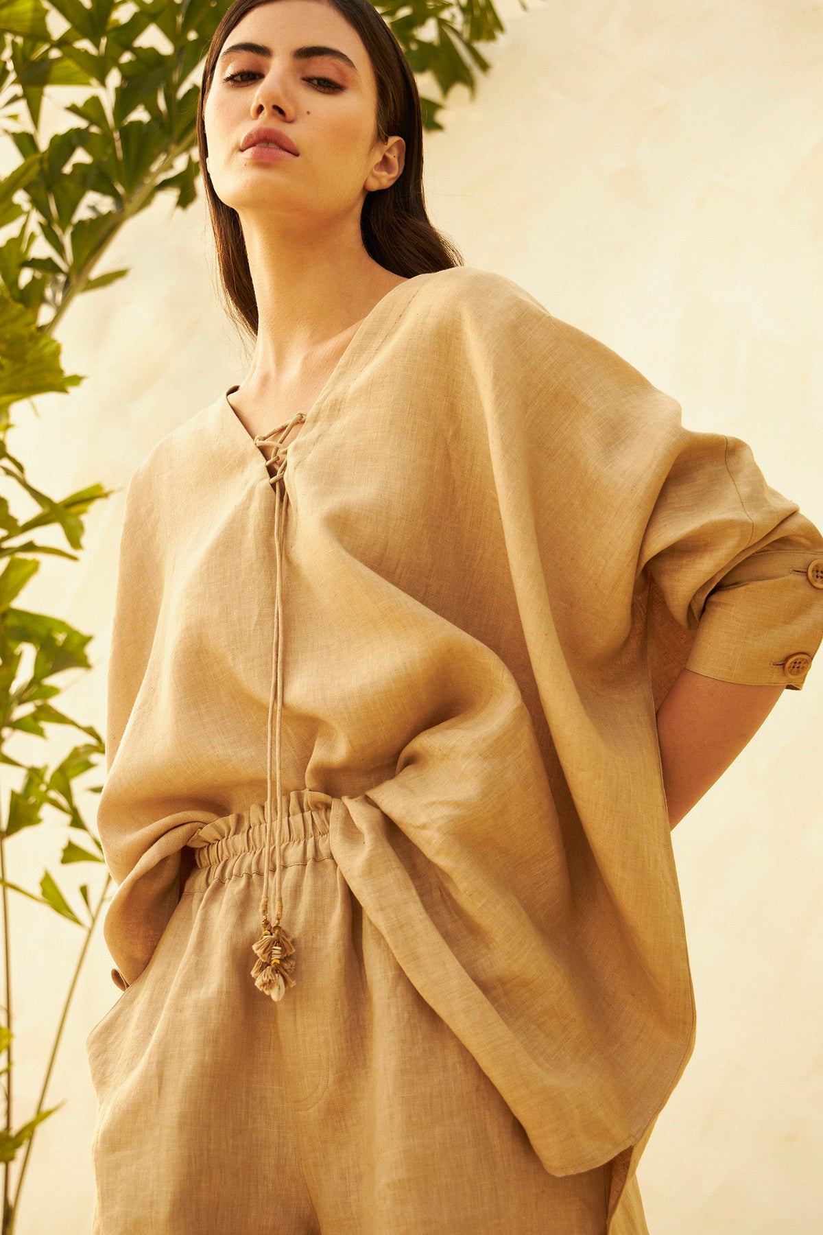 Woman wearing a beige relaxed-fit top and matching shorts