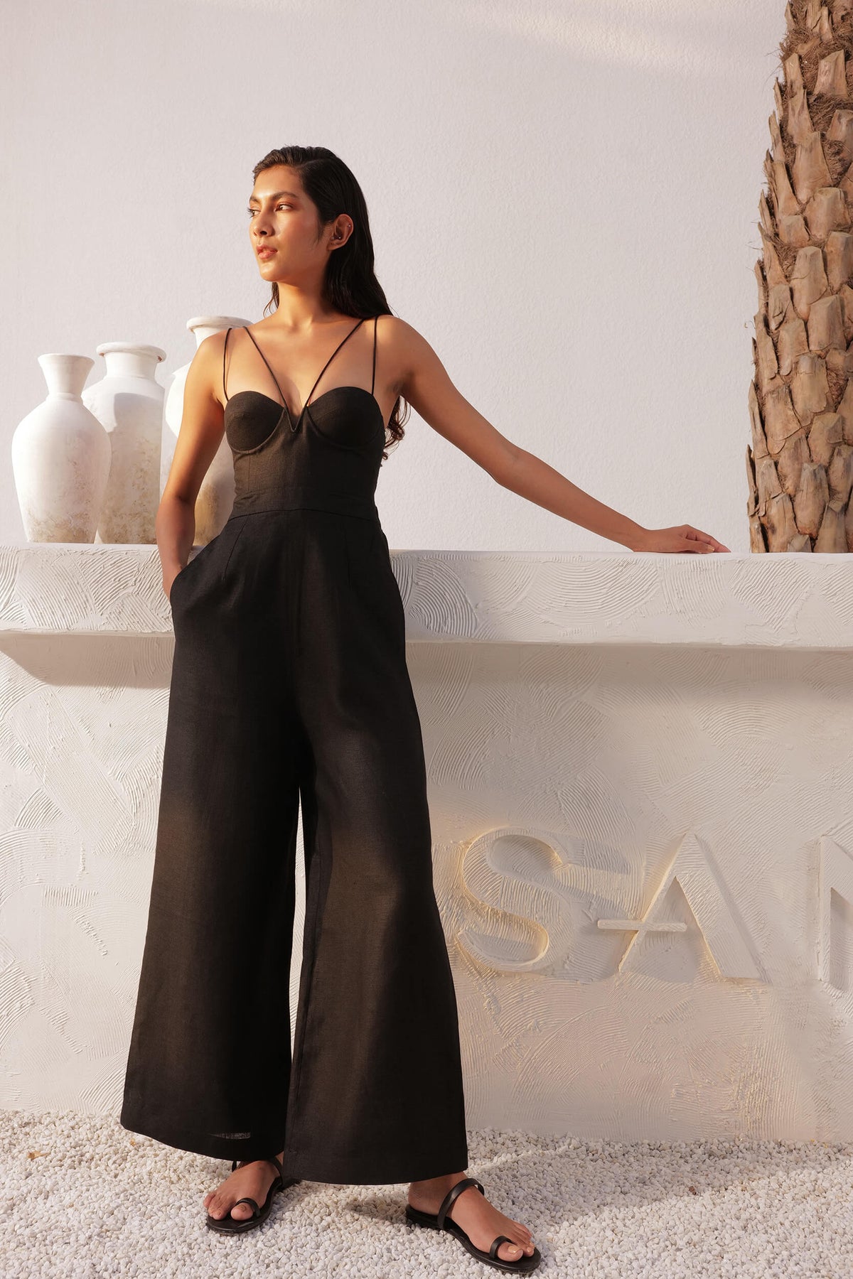 Woman wearing a black wide-leg jumpsuit outdoors