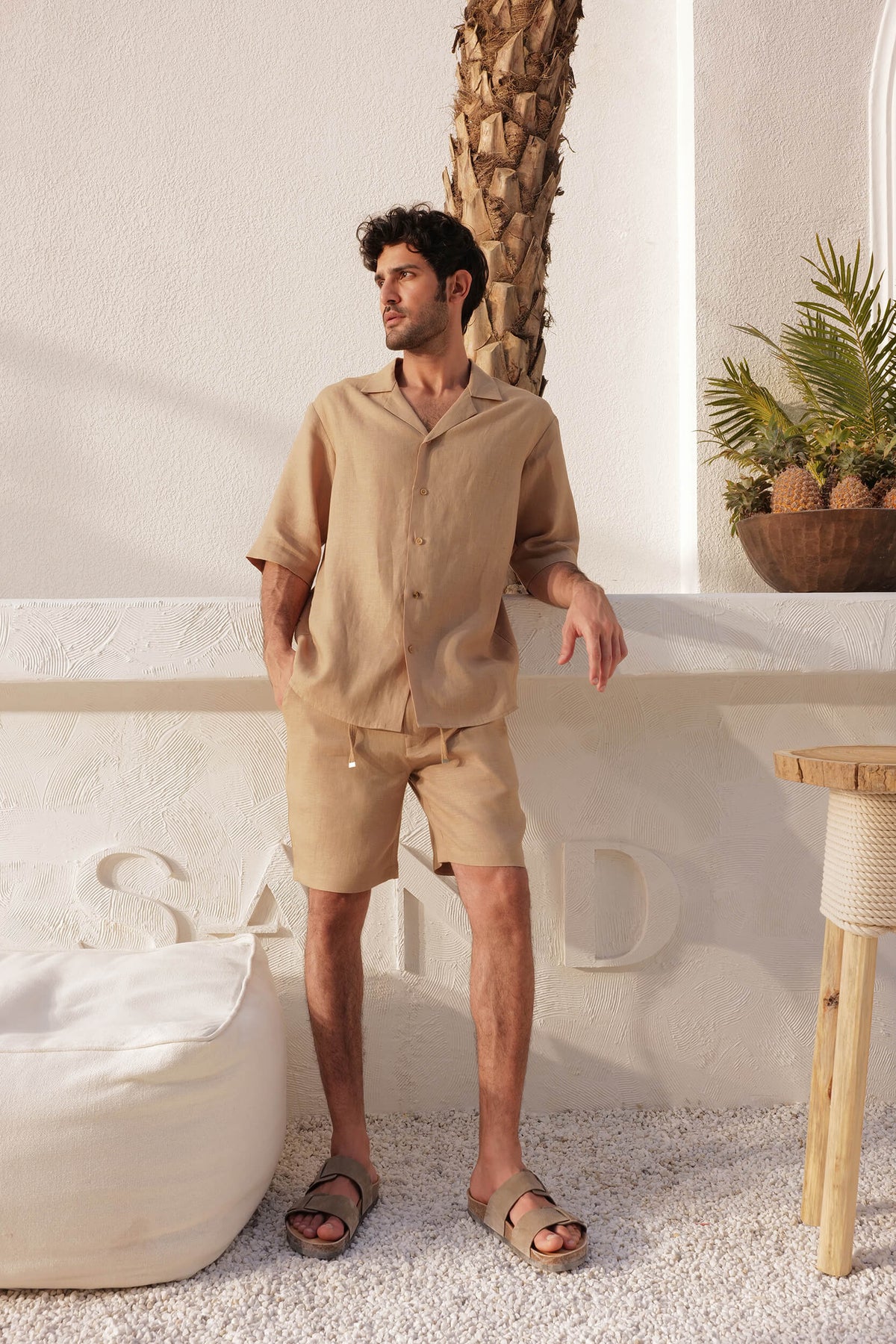 Man wearing a beige linen shirt and shorts set